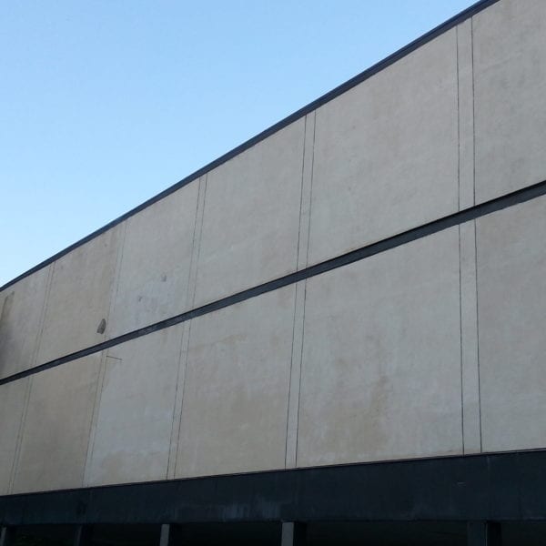 A skilled technician from Maryland Pro Wash is elevated on a cherry picker, diligently cleaning the exterior of a grand beige building with a flat roof, silhouetted against the clear blue sky. This meticulous service not only helps maintain the building's appearance but also extends its lifespan by removing dirt and grime. The structure features modern vertical and horizontal lines that segment its exterior panels, adding to its aesthetic appeal. Lush trees can be seen partially in view to the left, contributing to the picturesque setting.

Maryland Pro Wash proudly offers top-tier pressure washing services in Harford County MD, Baltimore County MD, Cecil County MD, Howard County MD, Carroll County MD, Anne Arundel County MD as well as Wilmington DE and New Castle County DE. Our expertise extends beyond Maryland into Delaware and through Delaware County PA ensuring that buildings across these areas remain pristine and protected from environmental elements.