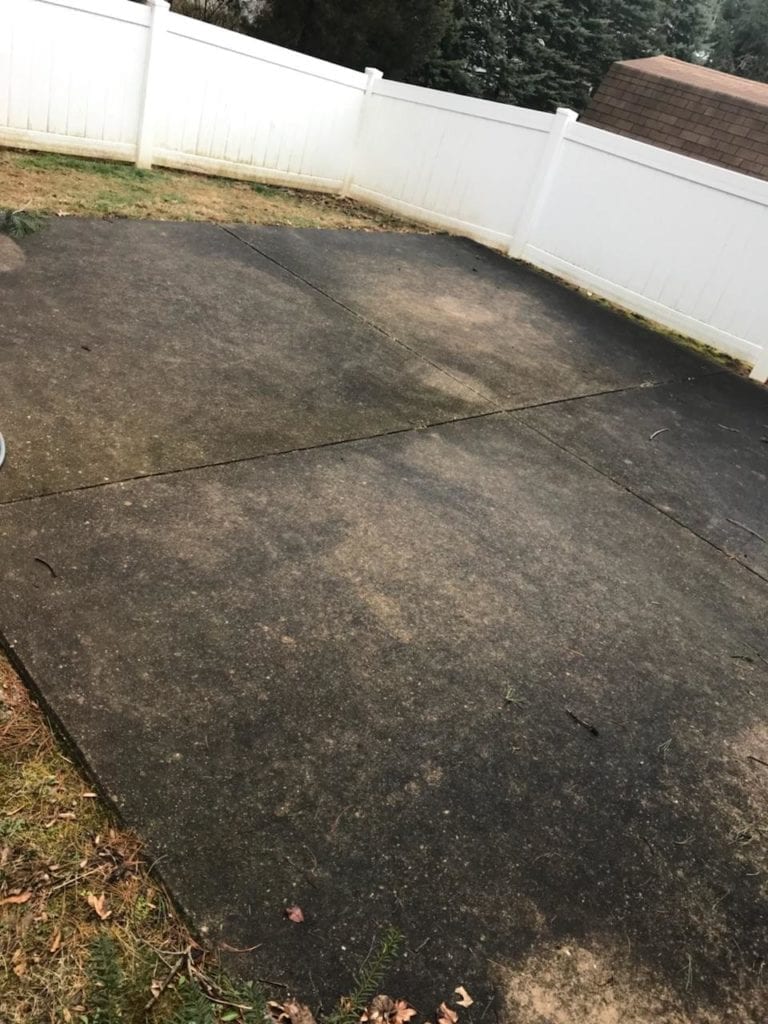 Before Pressure Washing Cement Backyard of a Residential House By Maryland Pro Wash