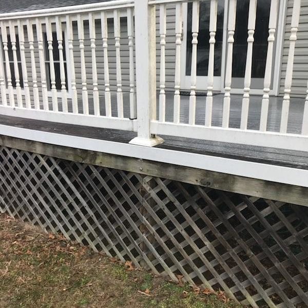 A wooden deck with white railings extends from a gray house, while the area beneath is enclosed with lattice panels, creating a charming and functional outdoor space. However, over time, decks and exterior surfaces can accumulate dirt and grime. This is where Maryland Pro Wash comes in. Specializing in professional pressure washing services across Harford County MD, Baltimore County MD, Cecil County MD, Howard County MD, Carroll County MD, Anne Arundel County MD as well as Wilmington DE, New Castle County DE and Delaware County PA. Maryland Pro Wash offers expert solutions to rejuvenate your home’s exterior by ridding it of unsightly patches of grass build-up and fallen leaves stains on surfaces like decks or siding. Trust their experienced team to enhance your property's curb appeal while protecting your investment.