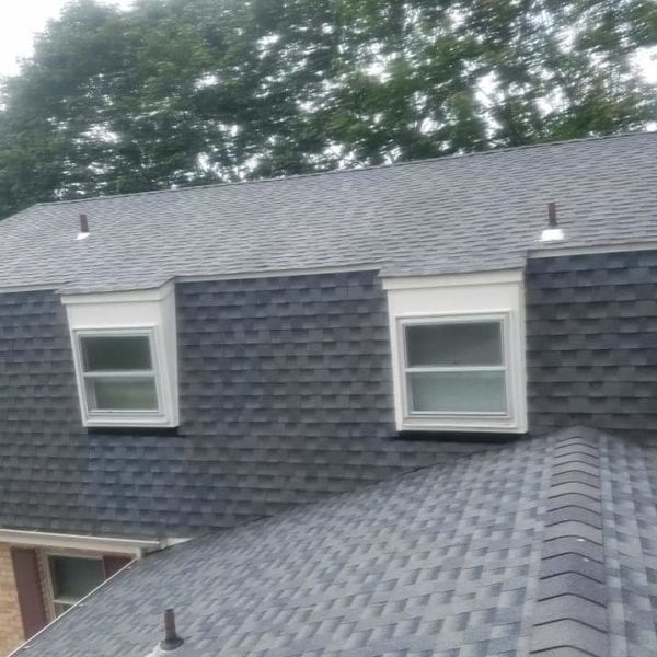 The image of the newly installed gray shingled roof with protruding windows and surrounding green trees might suggest that it's time to freshen up your property’s exterior. If you're looking to maintain or enhance the curb appeal of your home, consider Maryland Pro Wash's expert pressure washing services. 

Serving areas like Harford County, Baltimore County, Cecil County, Howard County, Carroll County, and Anne Arundel County in Maryland; Wilmington in Delaware; New Castle County in Delaware; and Delaware County in Pennsylvania—Maryland Pro Wash can help keep your roof and home exterior looking spotless. Whether it’s for the removal of dirt, mildew, or grime from any surface around your home or business property while possibly employing proven eco-friendly techniques.

The visible scaffolding indicates ongoing work for improvements—let Maryland Pro Wash be part of the finishing touch by ensuring every aspect of your property is clean and well-maintained!
