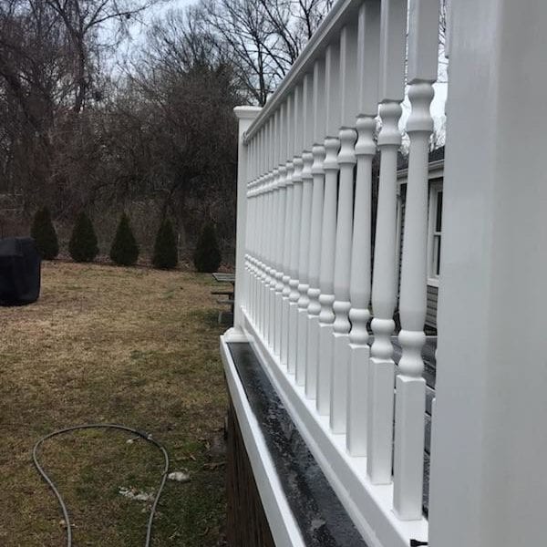 A freshly pressure-washed white wooden fence with spindle railings gleams brightly as it extends alongside a lush, grassy yard. Standing proudly against the backdrop of leafless trees and an overcast sky, this pristine fence showcases the exceptional results delivered by Maryland Pro Wash. Serving Harford County MD, Baltimore County MD, Cecil County MD, Howard County MD, Carroll County MD, Anne Arundel County MD — as well as Wilmington DE, New Castle County DE, and Delaware County PA — Maryland Pro Wash is your go-to expert for all pressure washing needs. Meticulously refreshing your property's exterior surfaces to ensure they look their absolute best is our specialty. Whether it's fences like this one or other outdoor areas that need revitalizing care from us; opt for unparalleled cleanliness across these regions today!