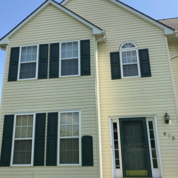 If you're looking for a professional pressure washing service to maintain the exterior of your home, including a beautiful yellow two-story house with dark green shutters and a matching front door, Maryland Pro Wash is an excellent choice. Serving areas such as Harford County, Baltimore County, Cecil County, Howard County, Carroll County, Anne Arundel County in Maryland; Wilmington in Delaware; New Castle County in Delaware; and Delaware County in Pennsylvania, they are committed to keeping your home in pristine condition.

Their expert team ensures that every surface of your house gleams as brightly as a clear sky. Whether it's the upper four windows or the lower three that need attention—or even if that blue ADT security sign needs cleaning—Maryland Pro Wash handles it all with care and precision. Your home's curb appeal can truly shine when you rely on their professional services to restore its exterior beauty effectively and efficiently.