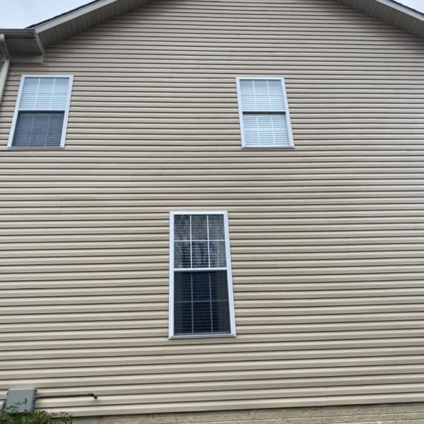 Maryland Pro Wash is your go-to expert for pressure washing services in the regions of Harford County MD, Baltimore County MD, Cecil County MD, Howard County MD, Carroll County MD, Anne Arundel County MD, Wilmington DE, New Castle County DE, and Delaware County PA. If your home bears the typical elements like a beige exterior with siding and brick-like accents as described in the image—complete with multiple windows and surrounding bushes—our professional power washing can restore its charm. Trust Maryland Pro Wash to make your home shine by effectively removing dirt and grime from all exterior surfaces. Contact us today for a refreshing clean that enhances curb appeal!
