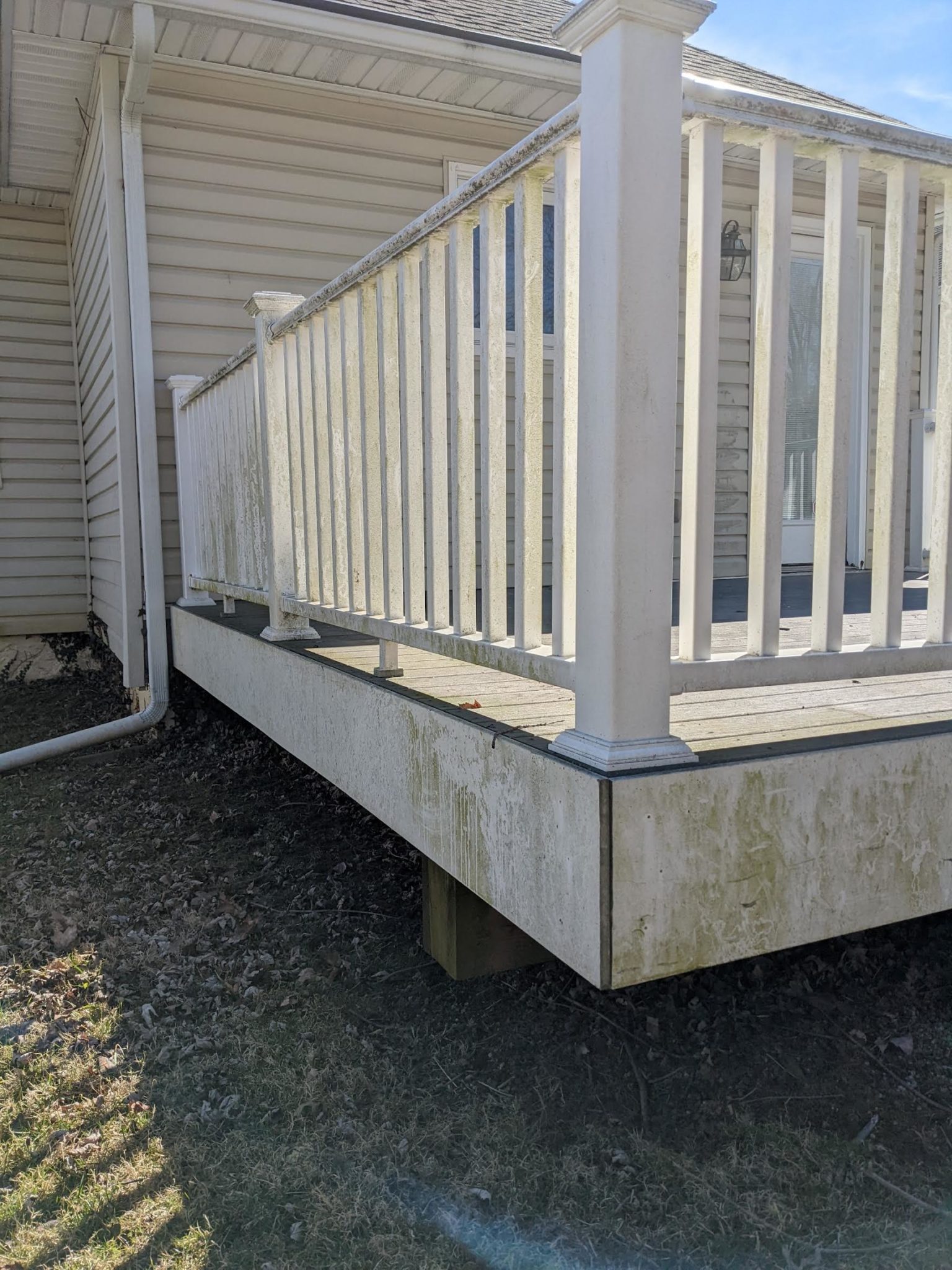 Dirty and weather-stained wooden deck and fence before pressure washing service by Maryland Pro Wash