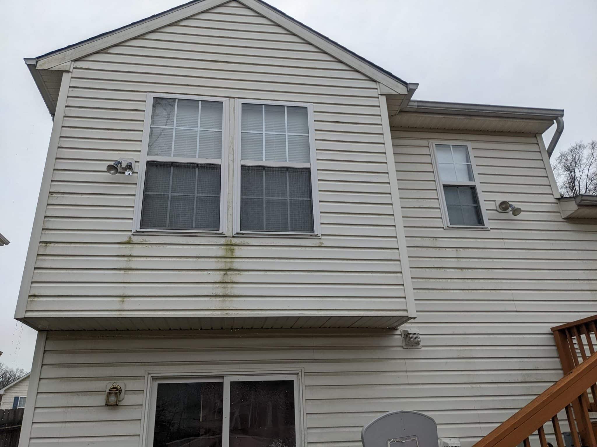 Home exterior before pressure washing by Maryland Pro Wash, showing siding with heavy staining and environmental buildup