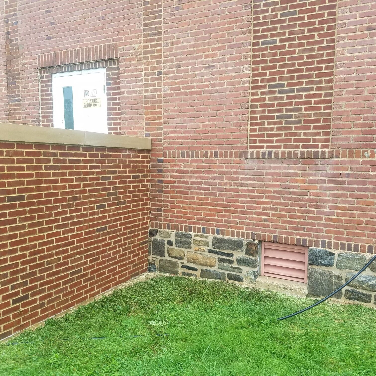 After Pressure Washing The Back of a Commercial Red Brick Church and Its White Doors By Maryland Pro Wash